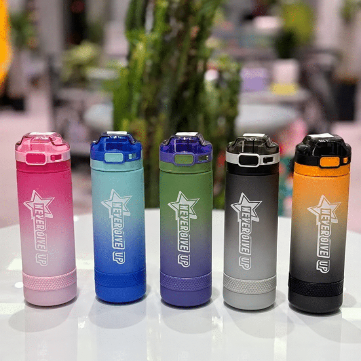 Five bottles on a blurred tabletop قمقمه آبین 650 میل قفل دار - تصویر 1