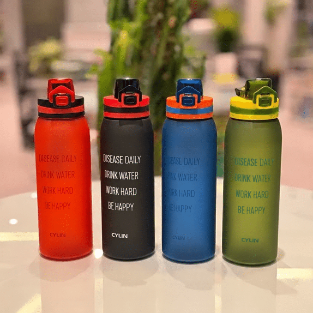 Four colorful bottles on a tabletop قمقمه ایوان پاستیلی 900 میل - تصویر 1